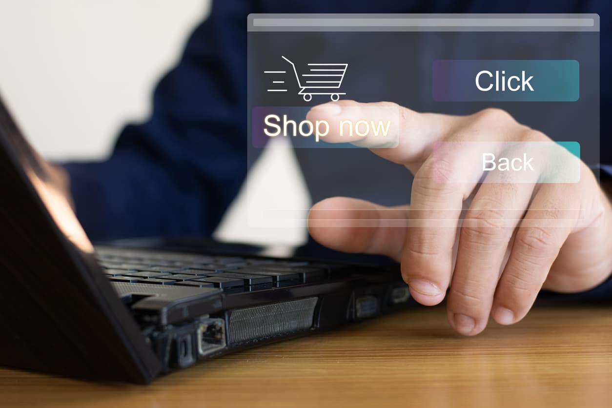 A hand pointing at online shopping icon